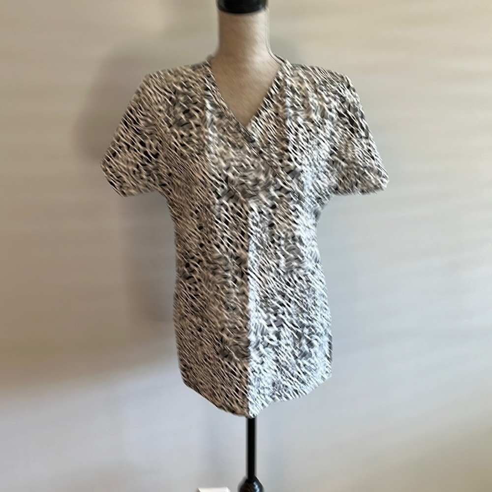 Animal print scrubs measures 21” armpit to armpit.  Looks brand new